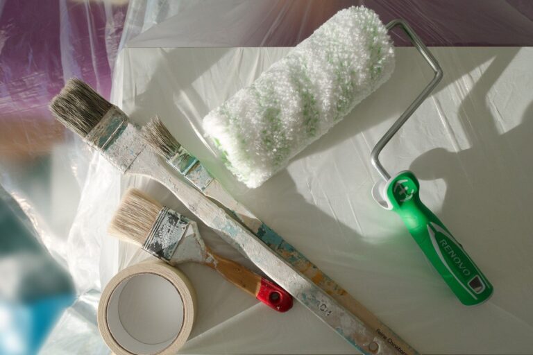Paint rollers, brushes, masking tape and other supplies for a home renovation