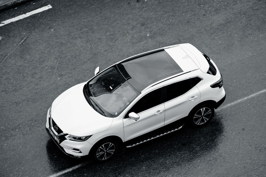 A white SUV is seen from above cruising along the wet streets of Istanbul, Turkey.