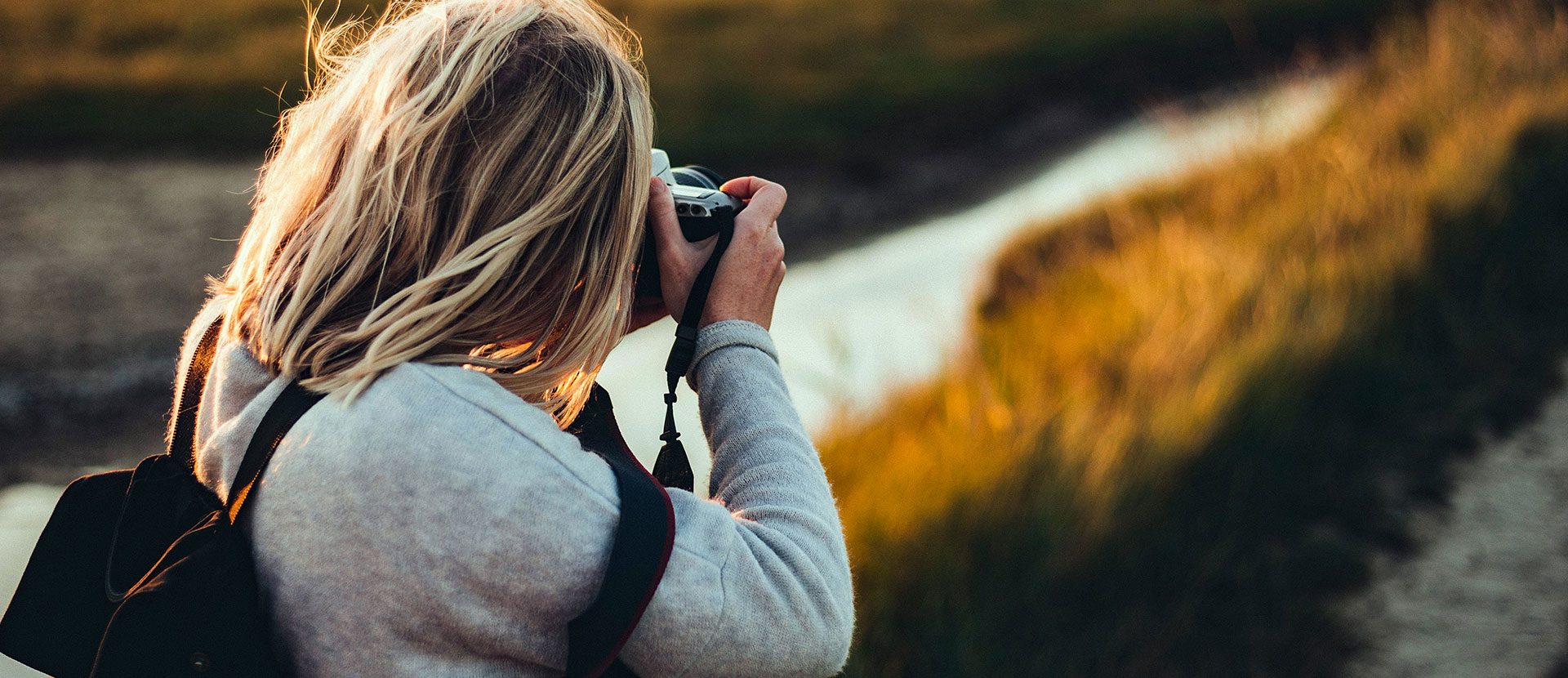 Woman taking a photo outdoors